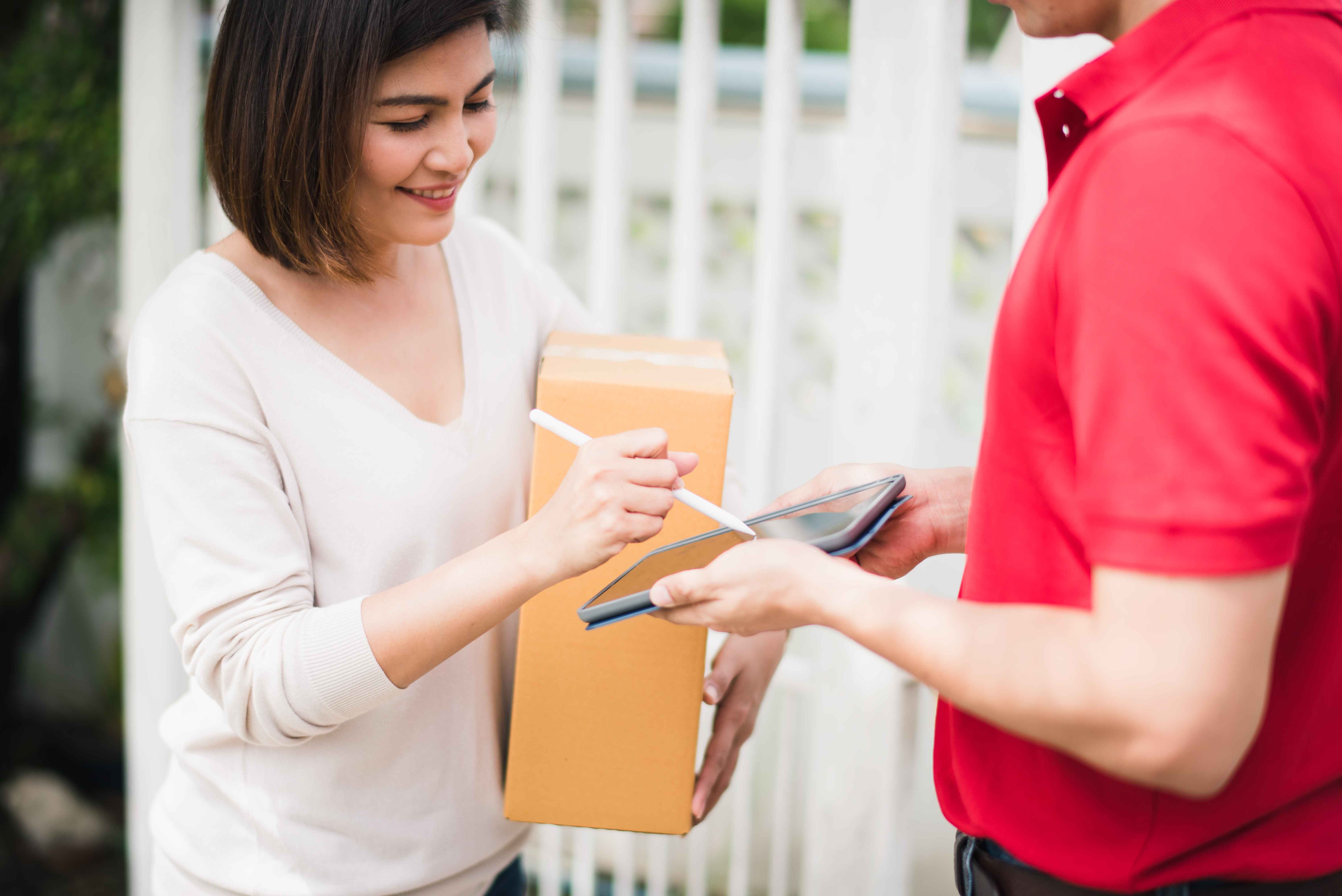 woman signing a receipt 